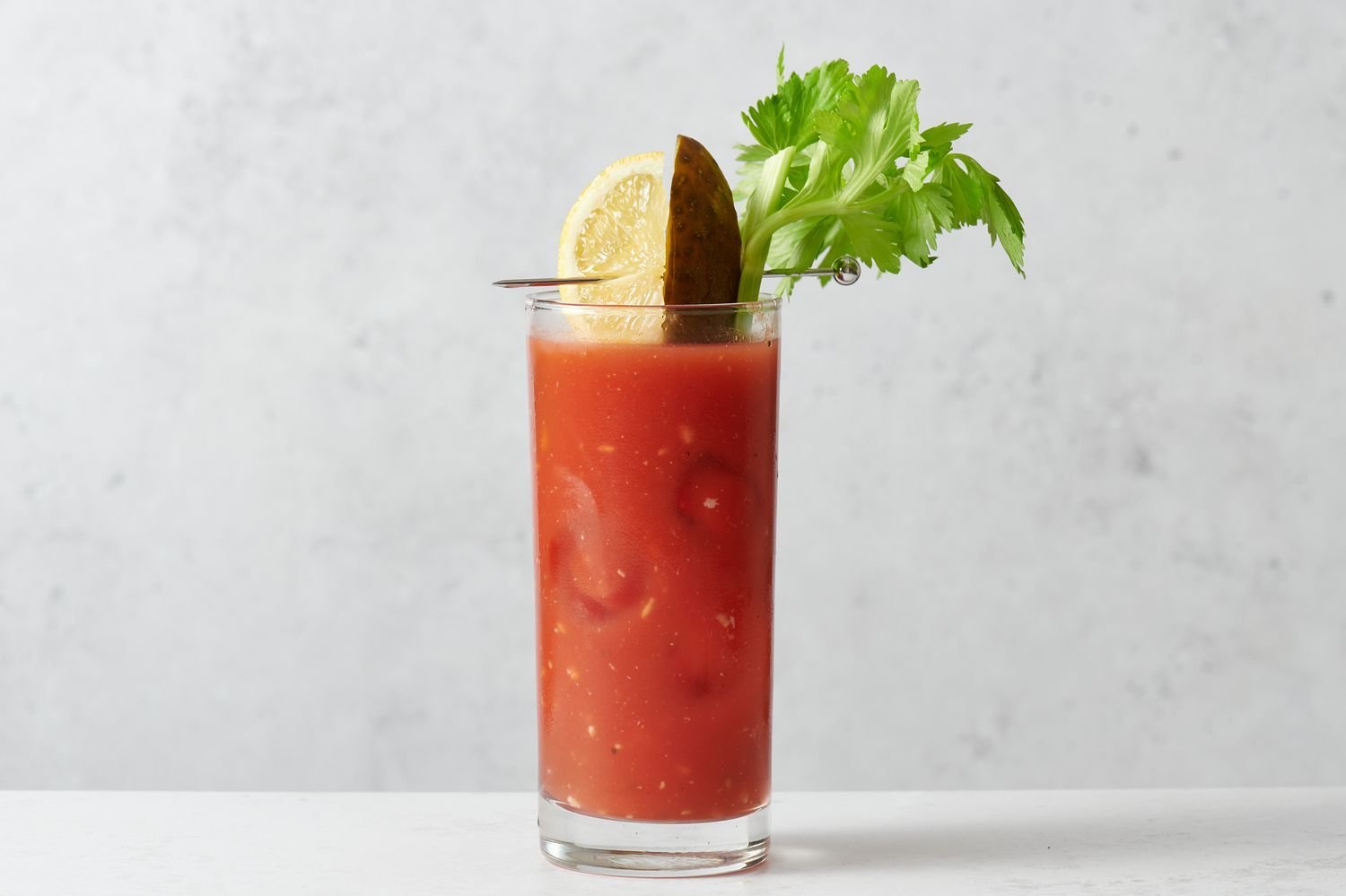 A swizzle stick stirring the drink