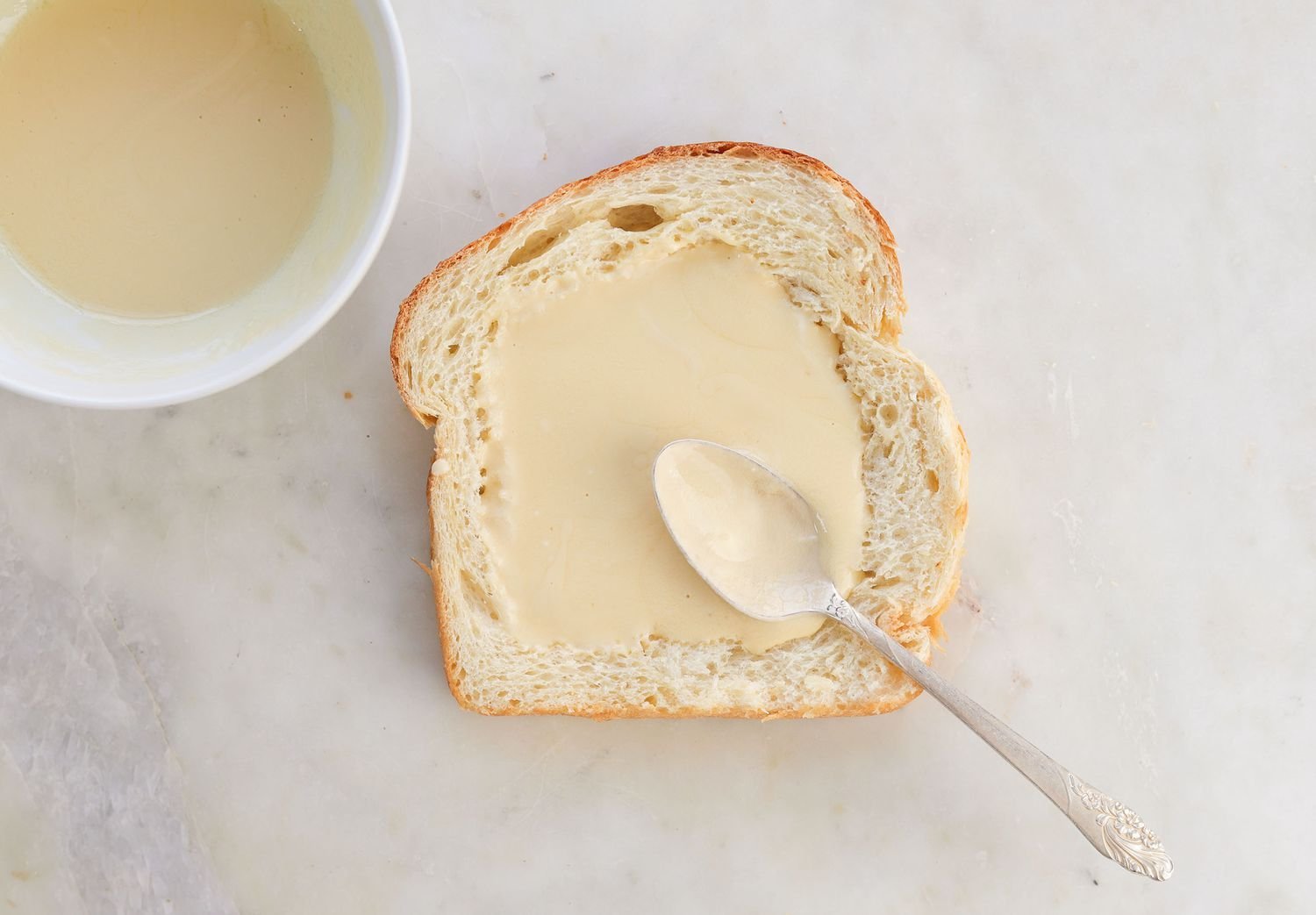 adding custard to the well of bread