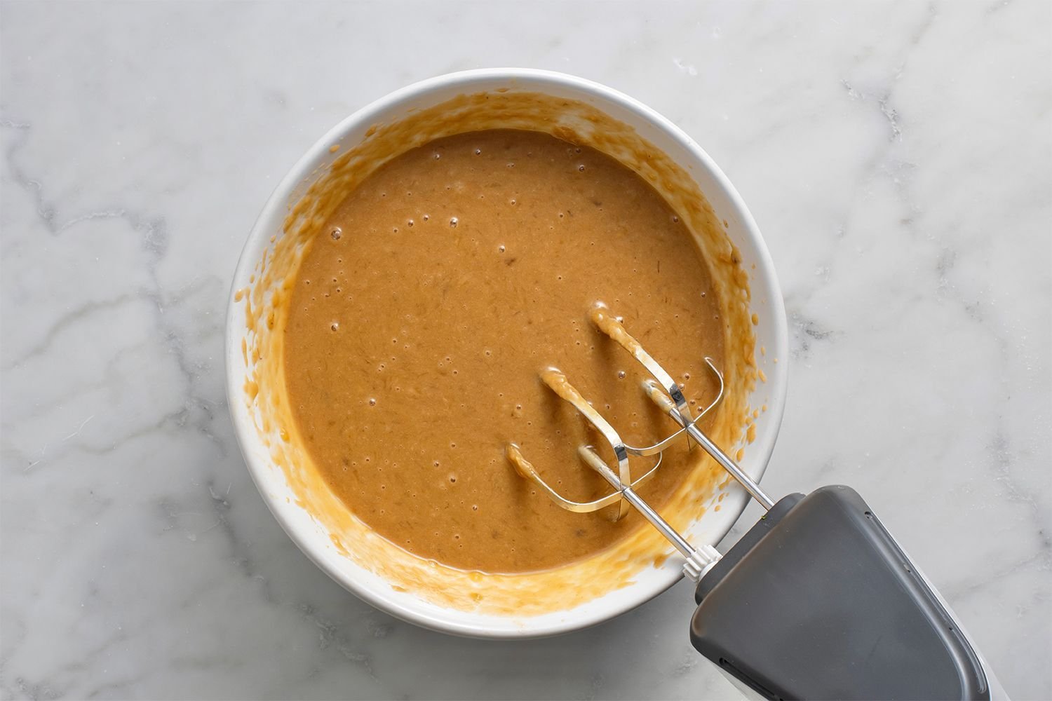 Peanut butter combined with the banana mixture in the bowl, using a hand mixer