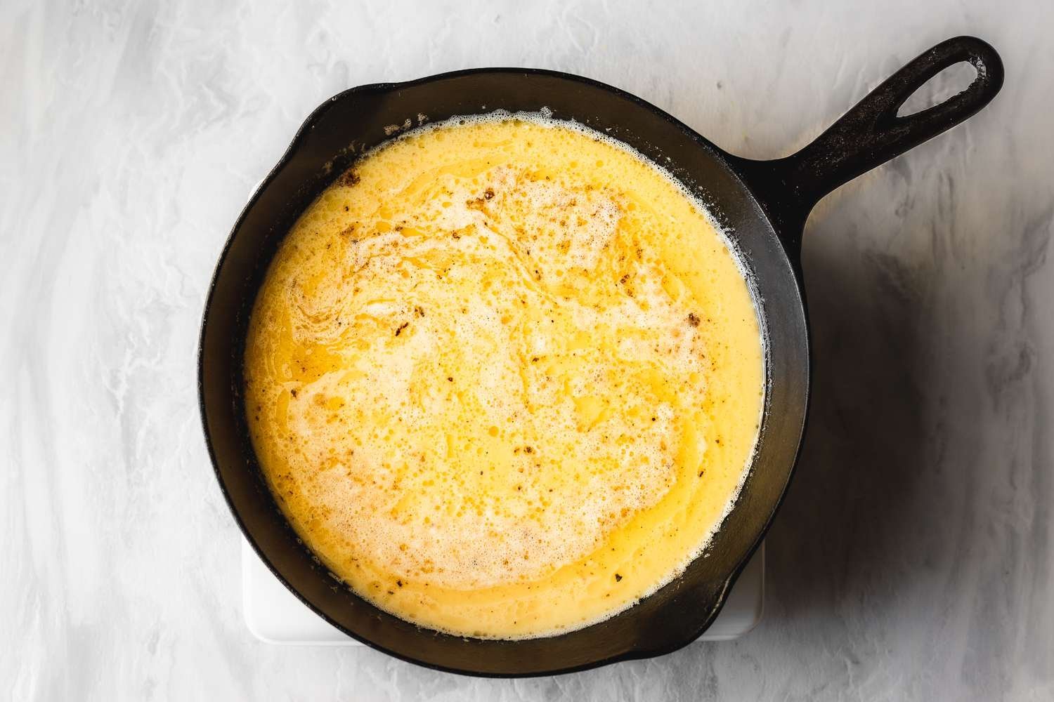 Scrambled egg mixture in cast iron skillet
