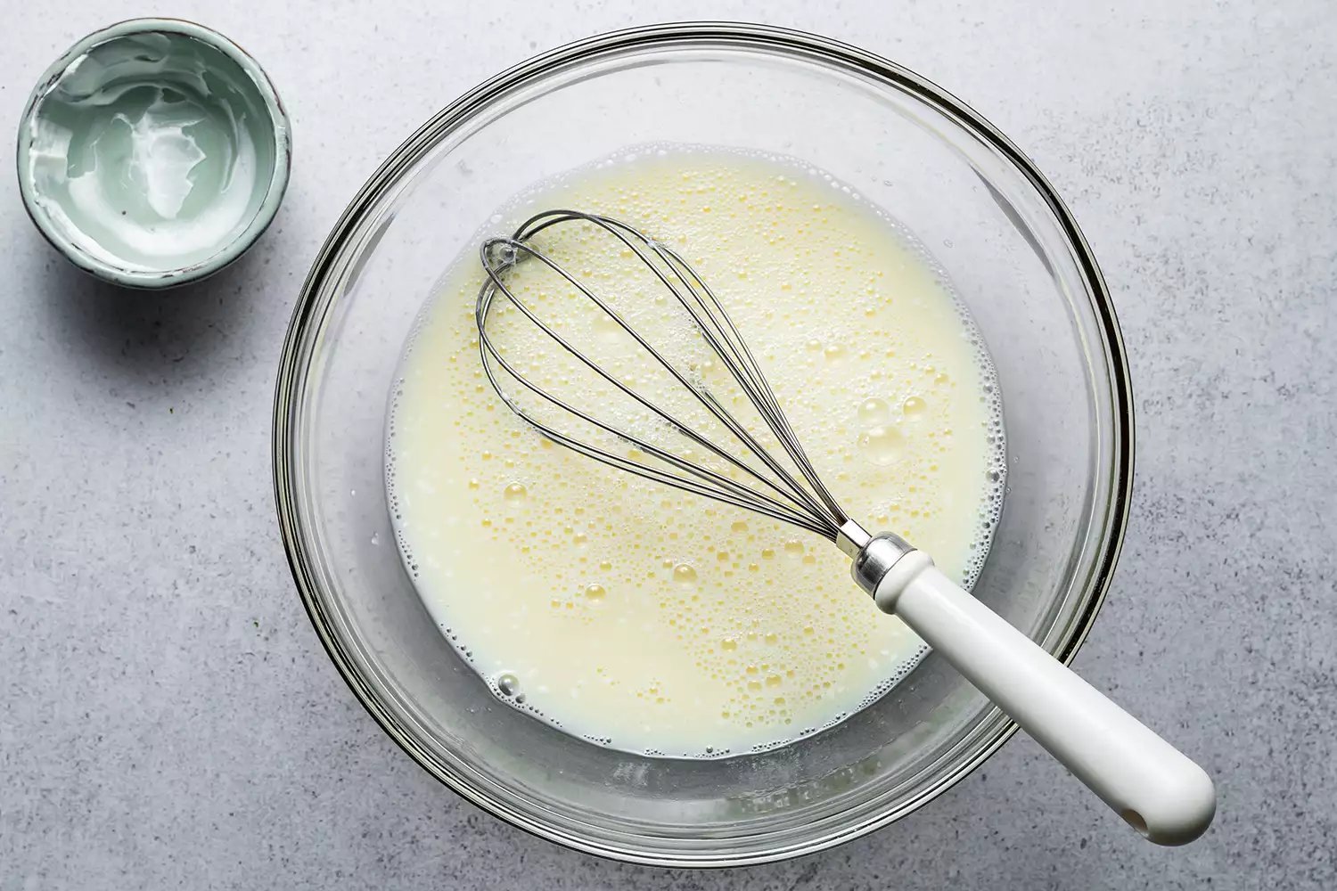 Uma tigela com clara de ovos e mistura de creme azedo